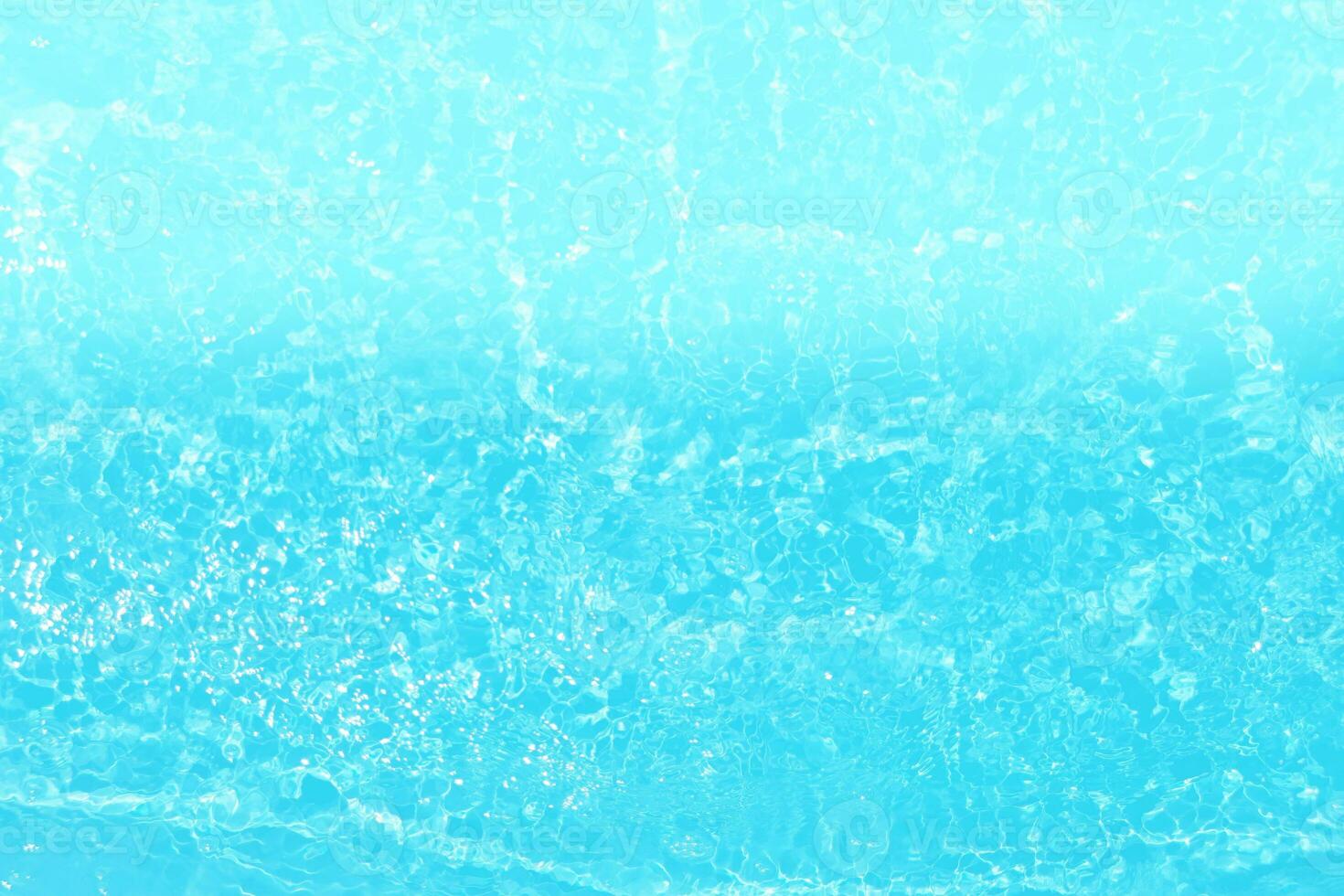 Blue water with ripples on the surface. Defocus blurred transparent blue colored clear calm water surface texture with splashes and bubbles. Water waves with shining pattern texture background. photo