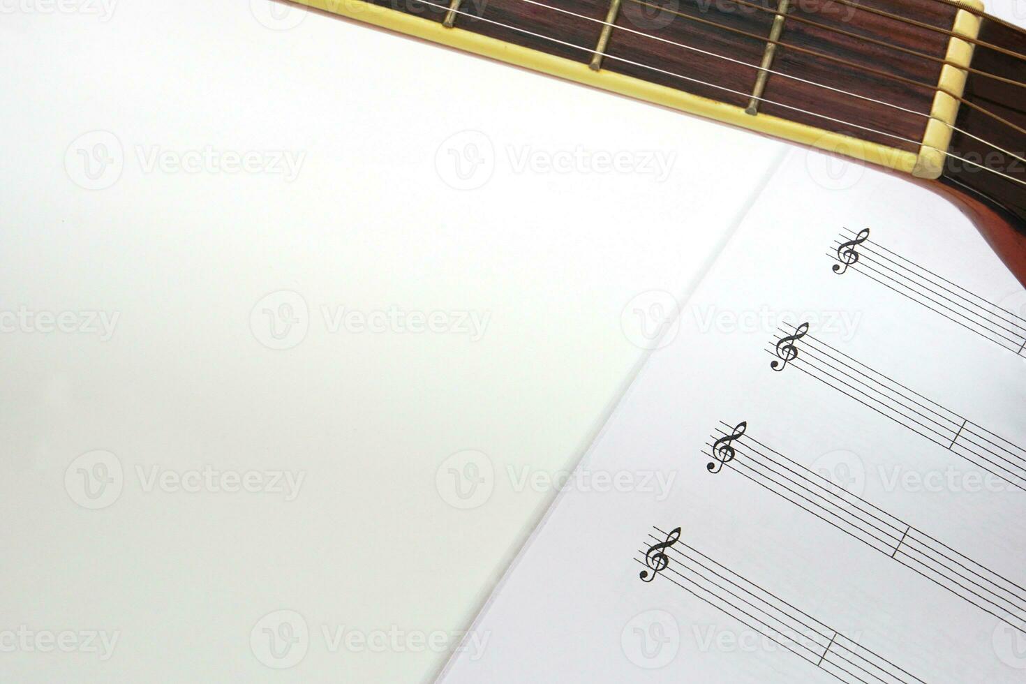 The acoustic guitar neck and musical notes on white background. Love, music and learning concept. photo