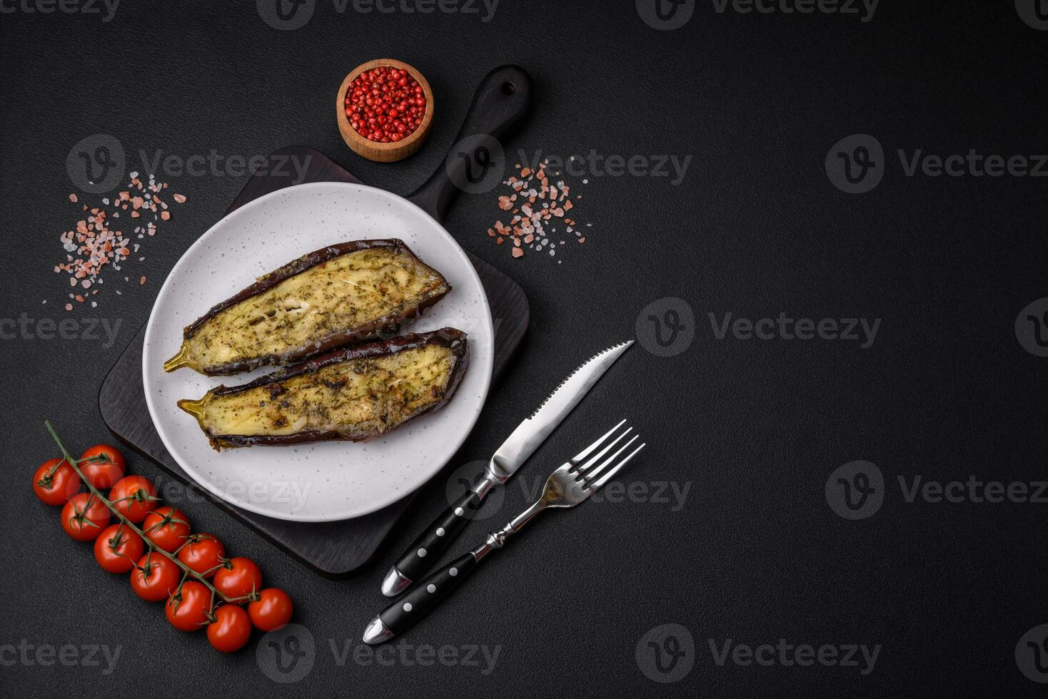 Delicious eggplant cut into two halves baked with salt, spices and herbs photo