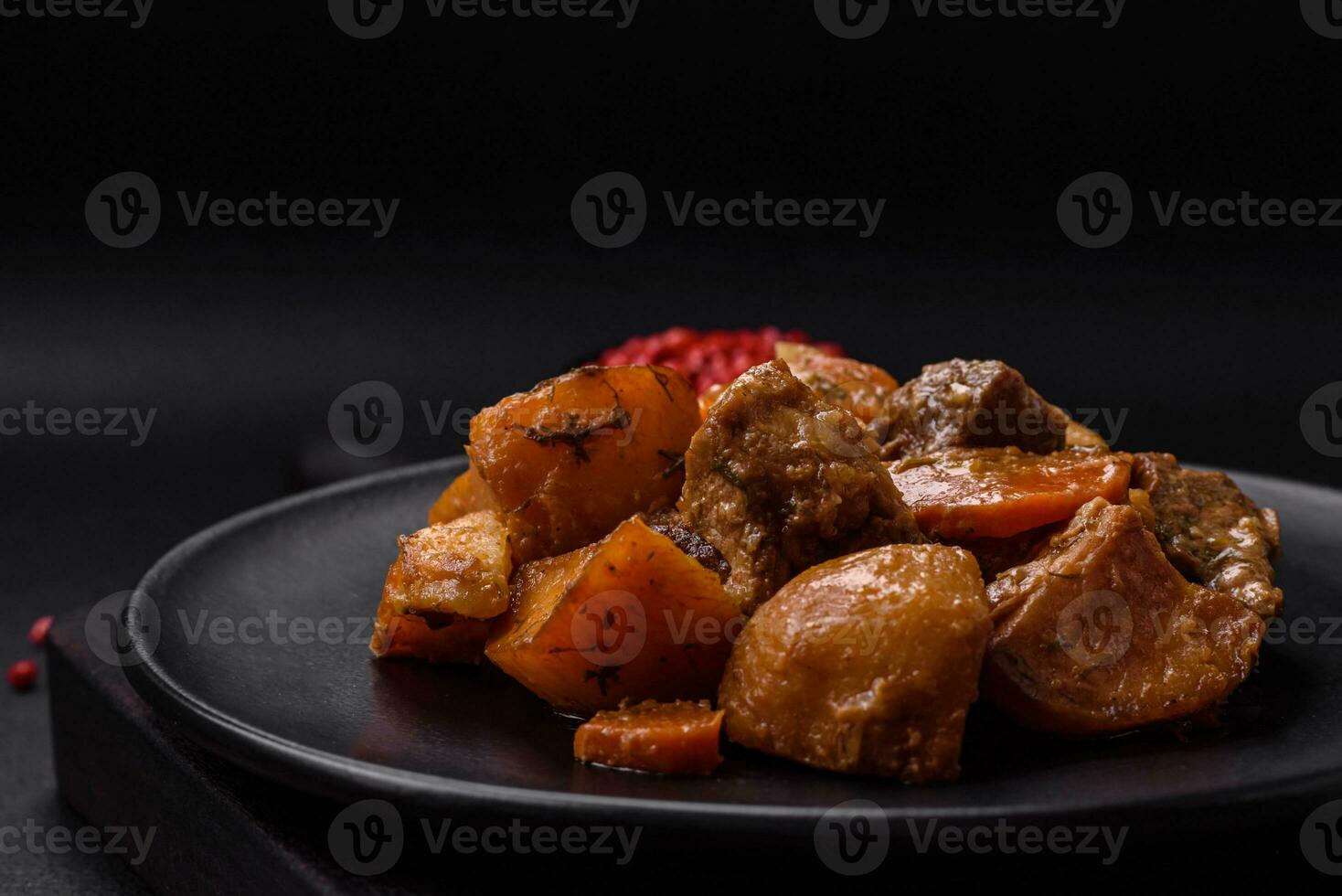 Delicious fresh cooked stew with pork meat or beef with potatoes, carrots, spices and herbs photo