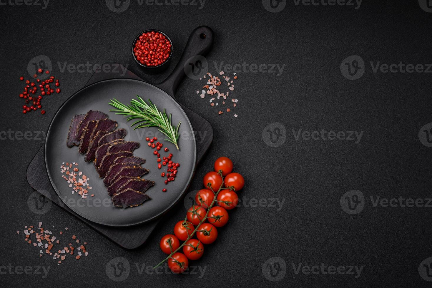 Delicious dried smoked beef or horse meat jerky with spices and salt photo