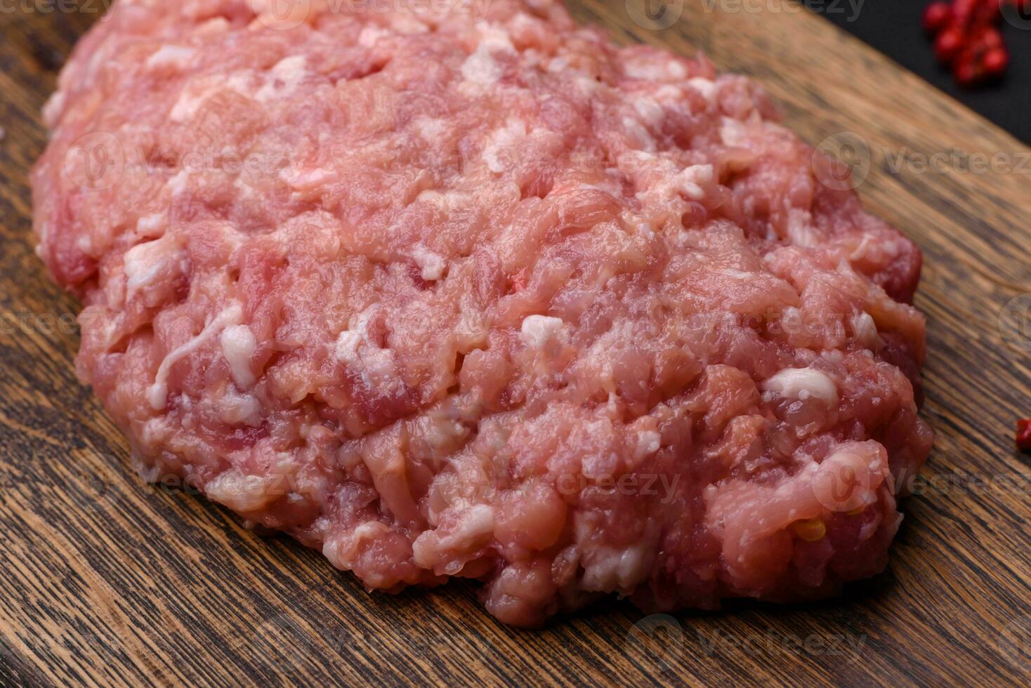 Raw minced beef, pork or chicken meat with salt, spices and herbs photo