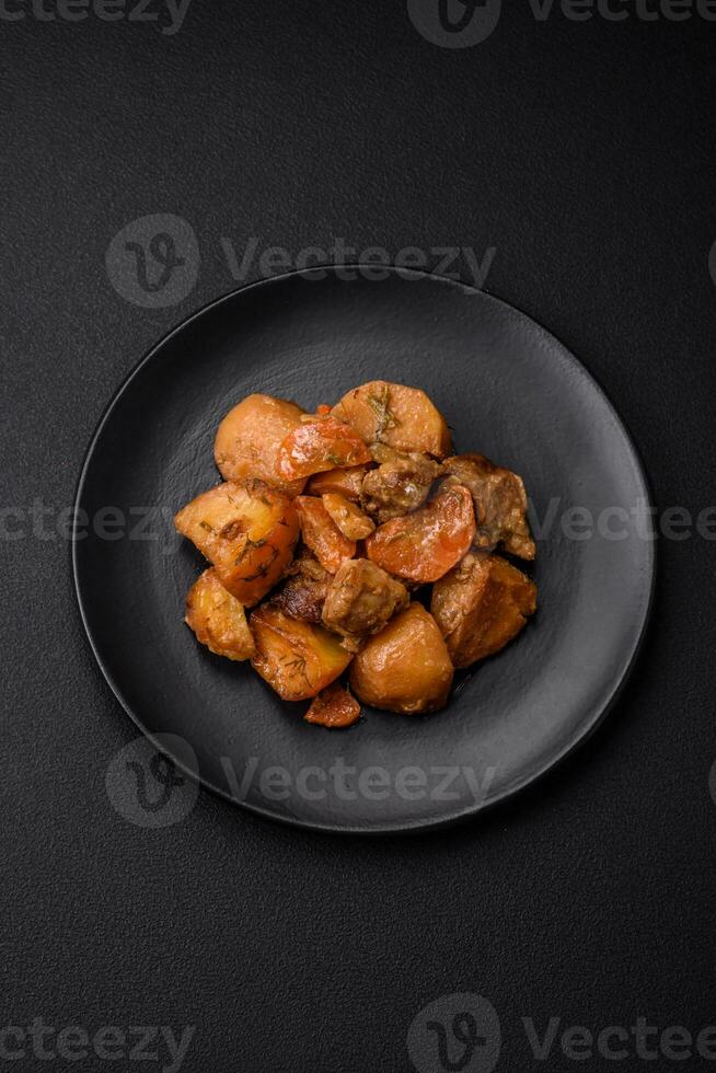 Delicious fresh cooked stew with pork meat or beef with potatoes, carrots, spices and herbs photo