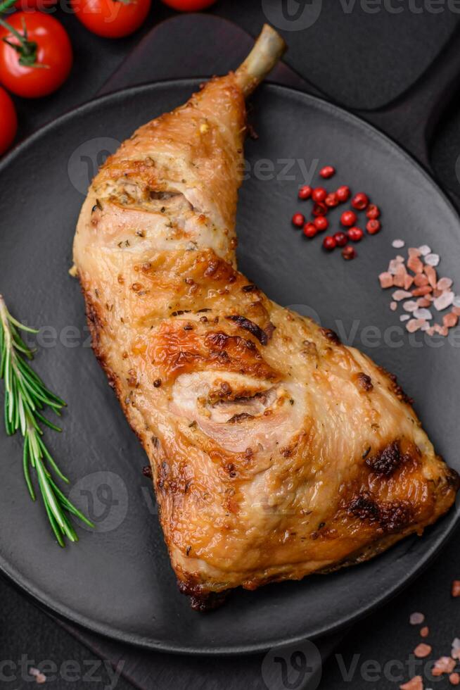 Fresh grilled chicken leg with salt, spices and herbs photo