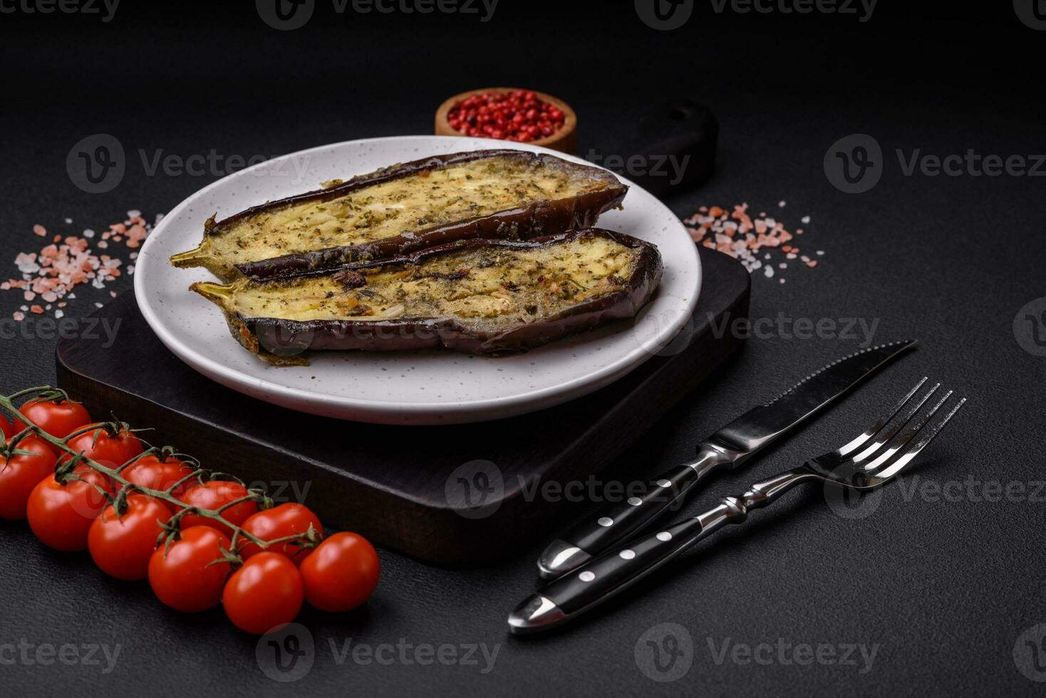 Delicious eggplant cut into two halves baked with salt, spices and herbs photo