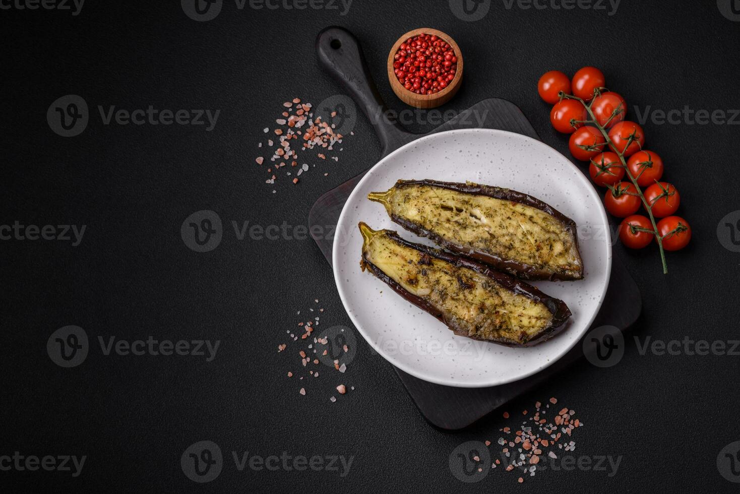 Delicious eggplant cut into two halves baked with salt, spices and herbs photo