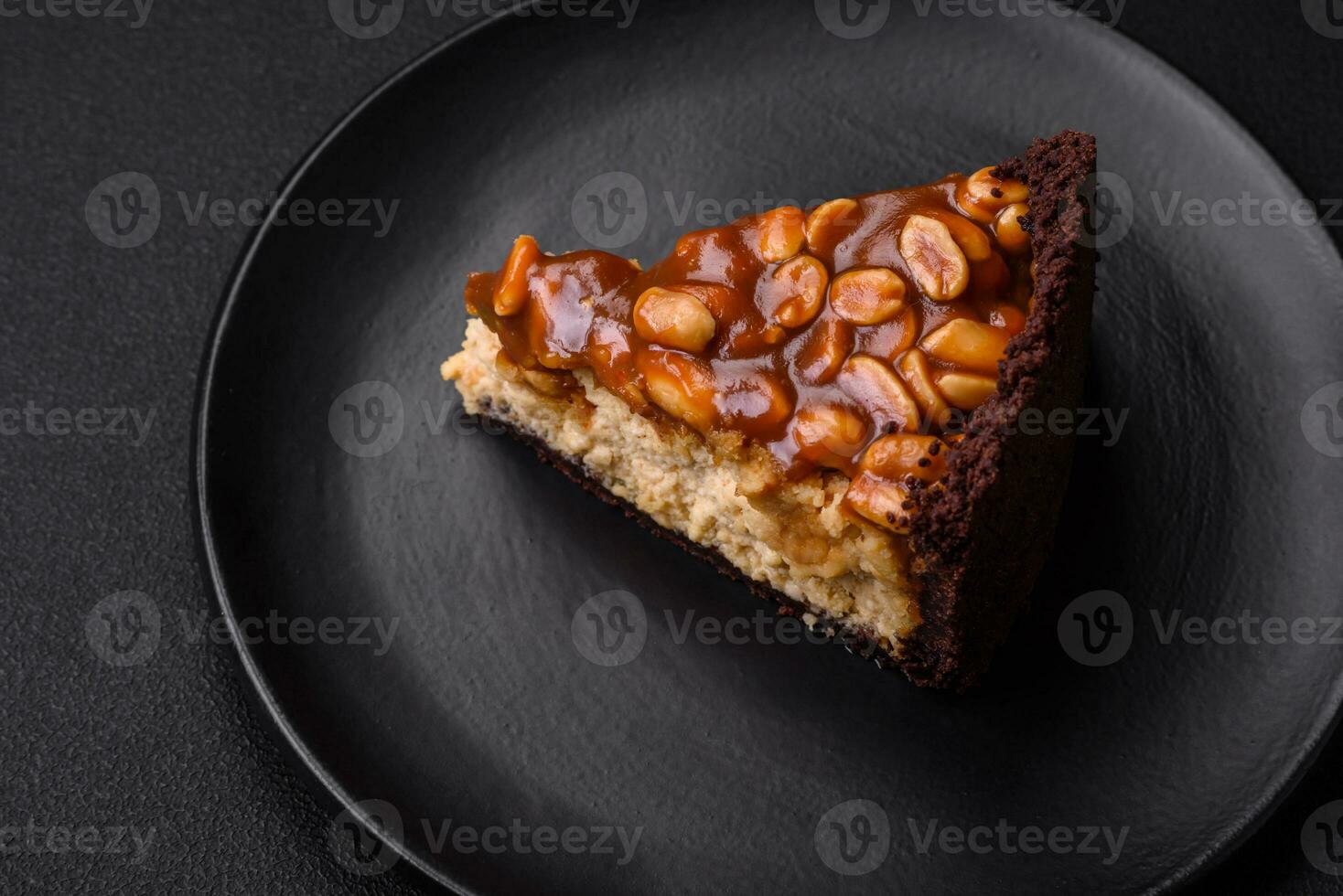 Delicious fresh cheesecake cake or snickers with cream and nuts photo