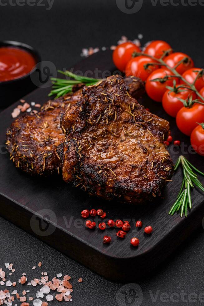 Delicious beef or pork steak on the bone grilled with spices and rosemary photo