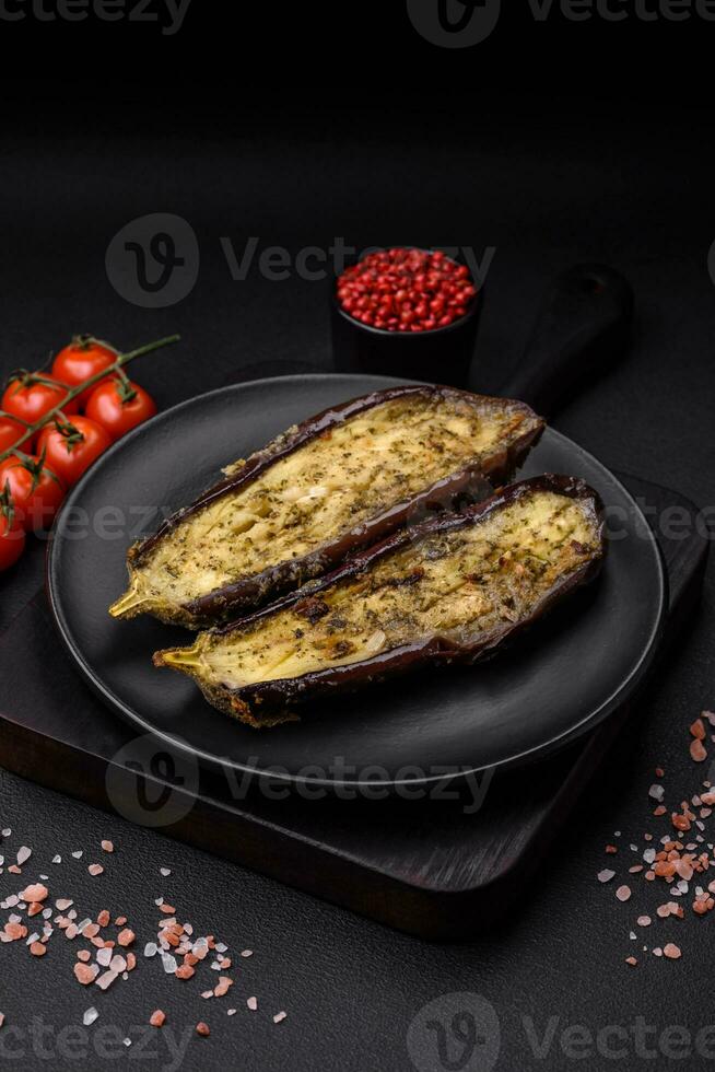 Delicious eggplant cut into two halves baked with salt, spices and herbs photo