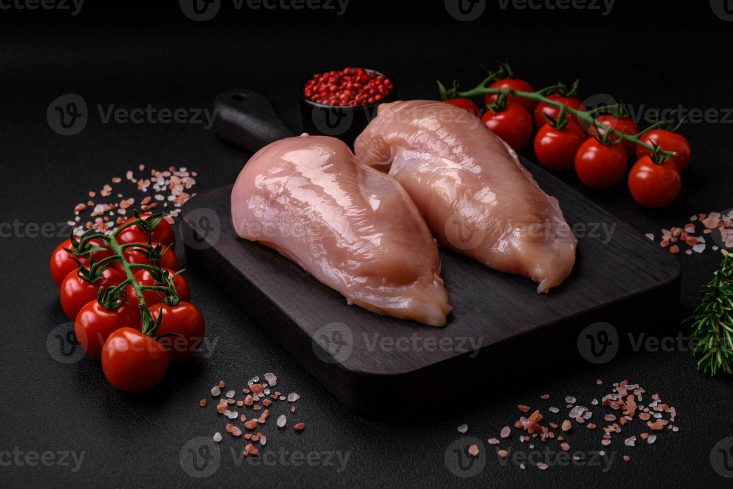 Pieces of raw chicken or turkey fillet with salt, spices and herbs photo