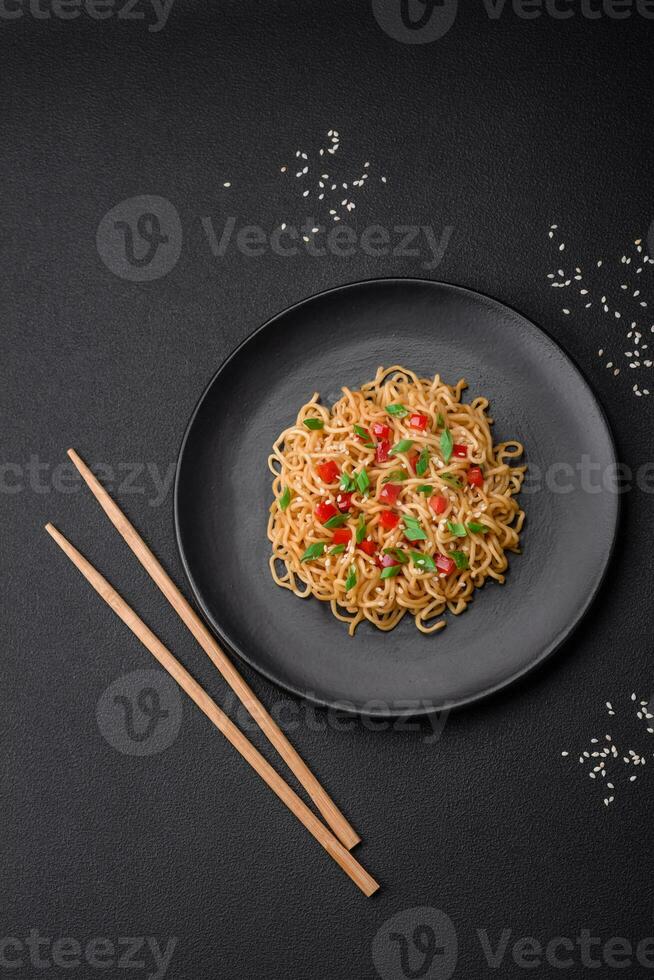 Delicious fresh Asian noodles with vegetables, salt, spices and herbs photo