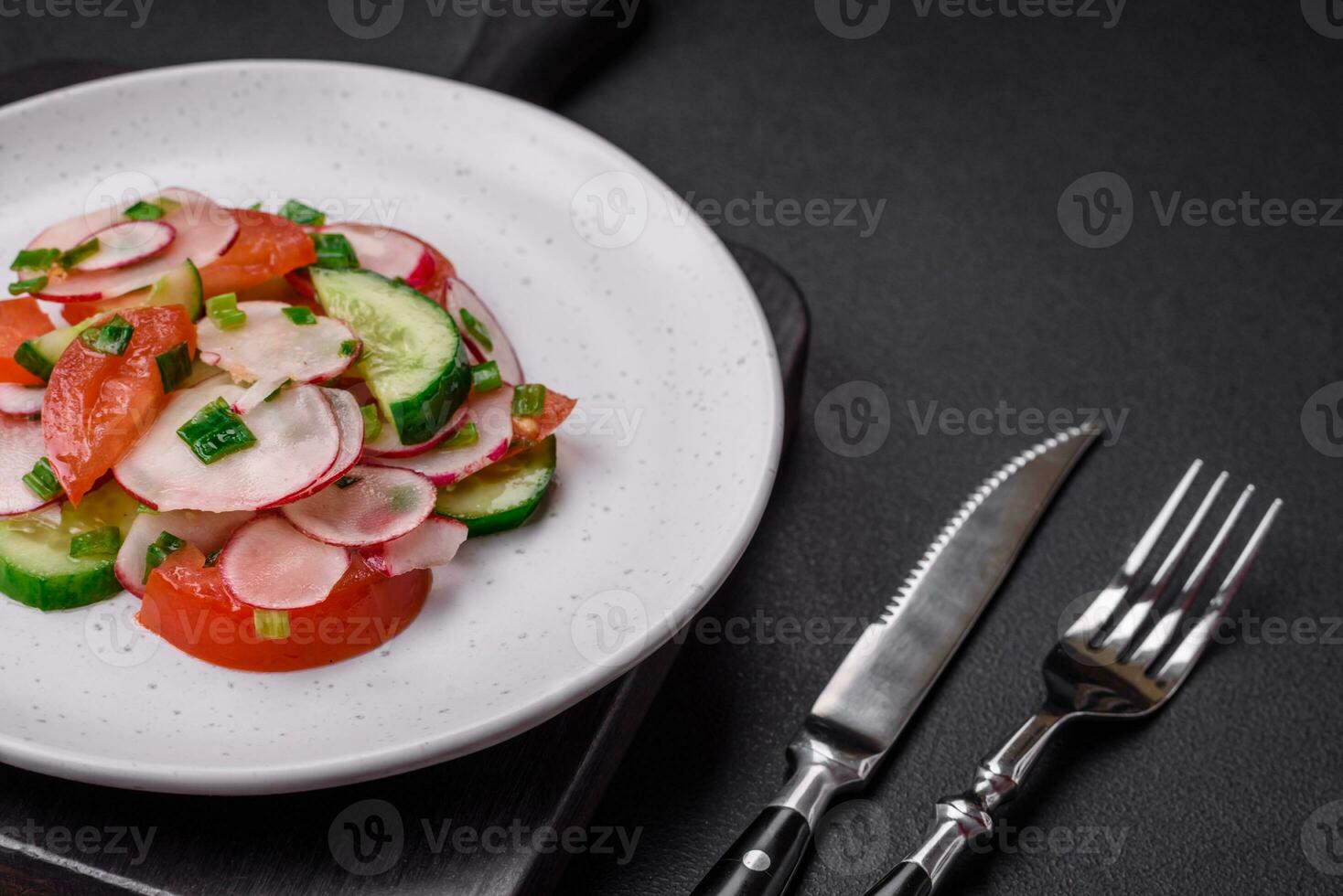 Delicious vegan salad of fresh vegetables of tomatoes, cucumbers and radishes photo
