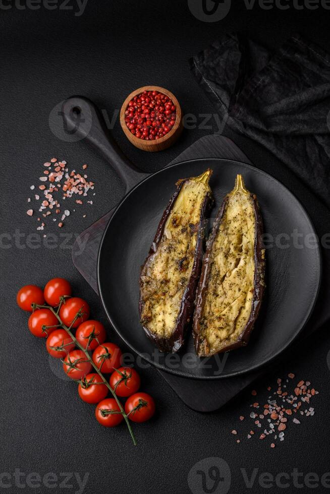 Delicious eggplant cut into two halves baked with salt, spices and herbs photo