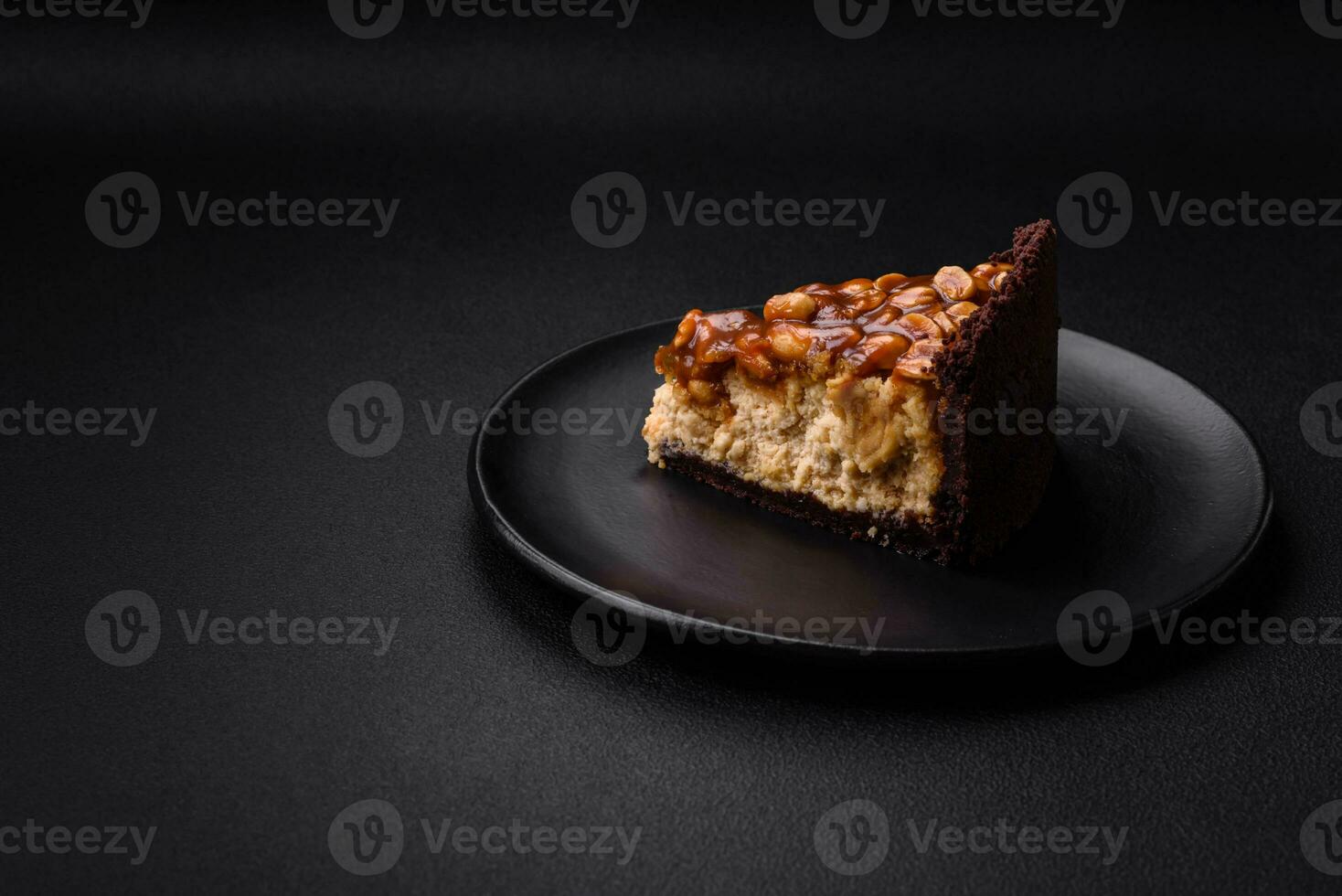 Delicious fresh cheesecake cake or snickers with cream and nuts photo