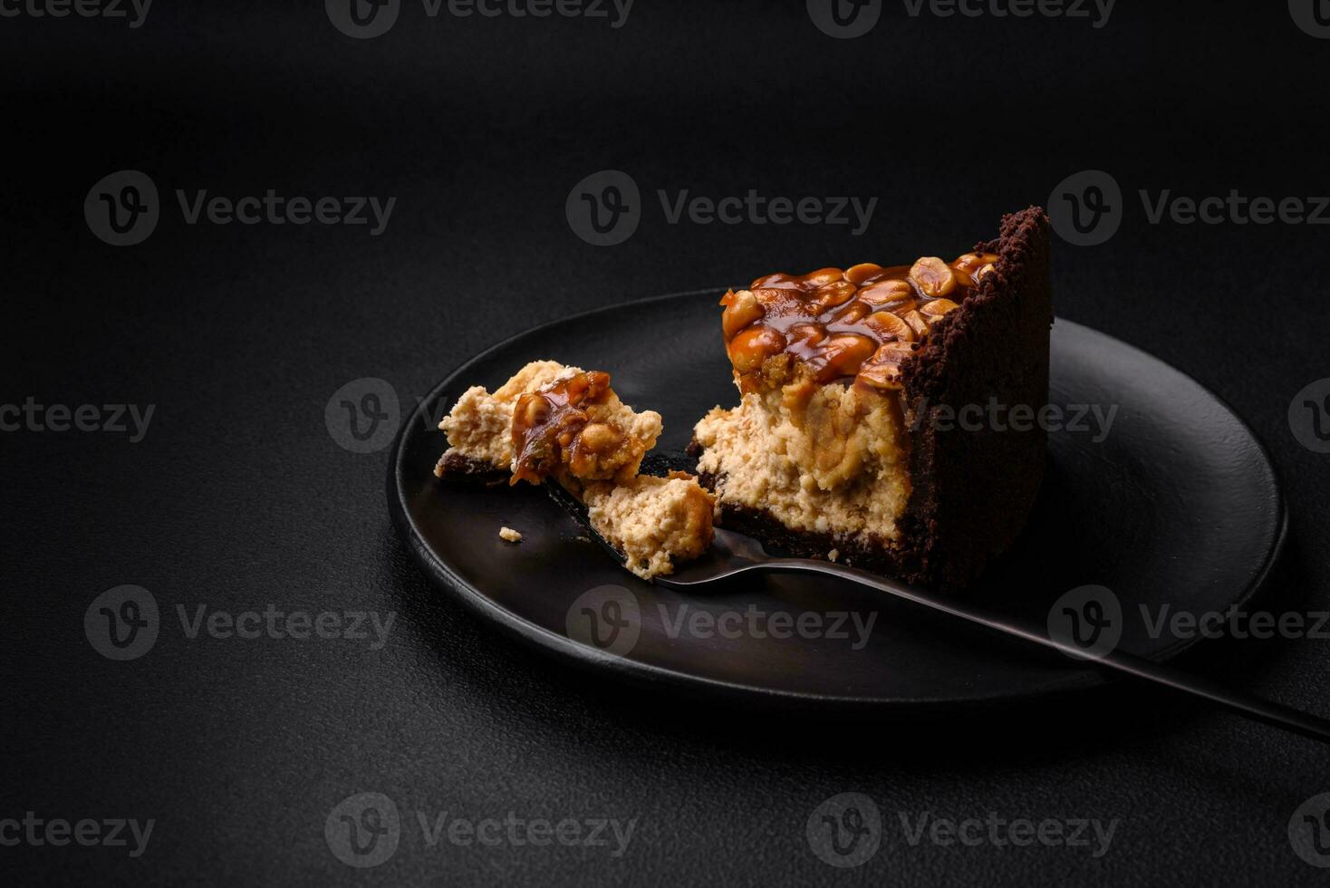 Delicious fresh cheesecake cake or snickers with cream and nuts photo