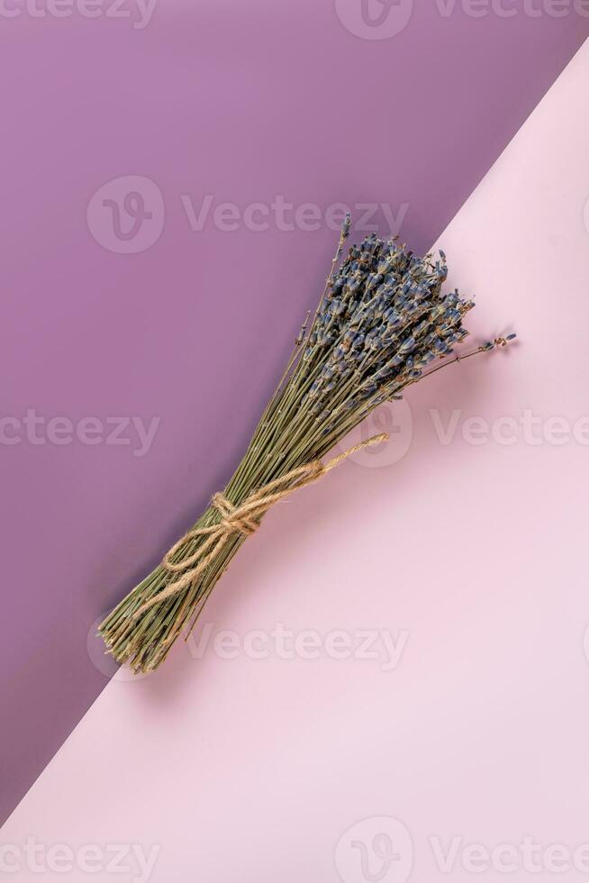 Dry lavender bouquet on double lilac background. Bunch of flowers. Aromatherapy photo