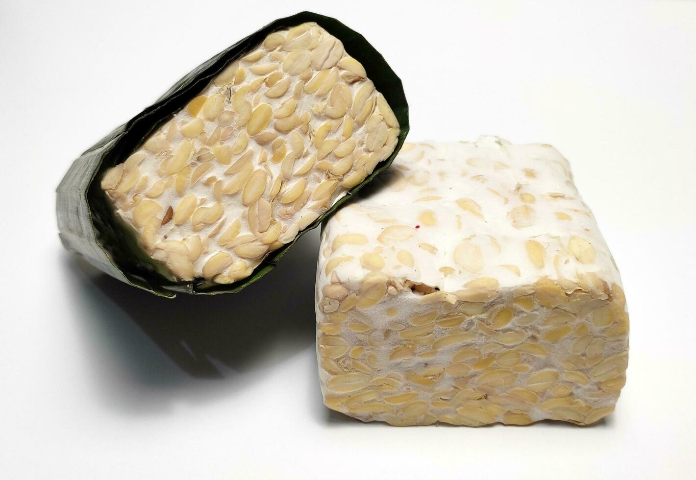 Raw Tempeh or Tempe, Indonesian traditional food, made from fermented soybeans, On White Background. photo