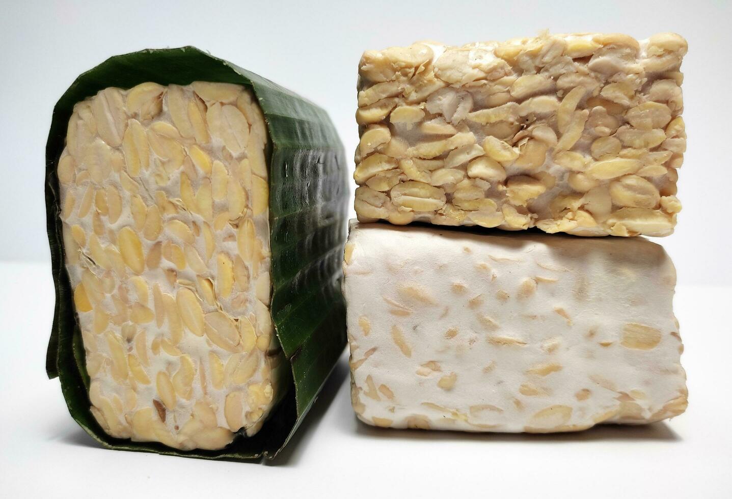 Raw Tempeh or Tempe, Indonesian traditional food, made from fermented soybeans, On White Background. photo
