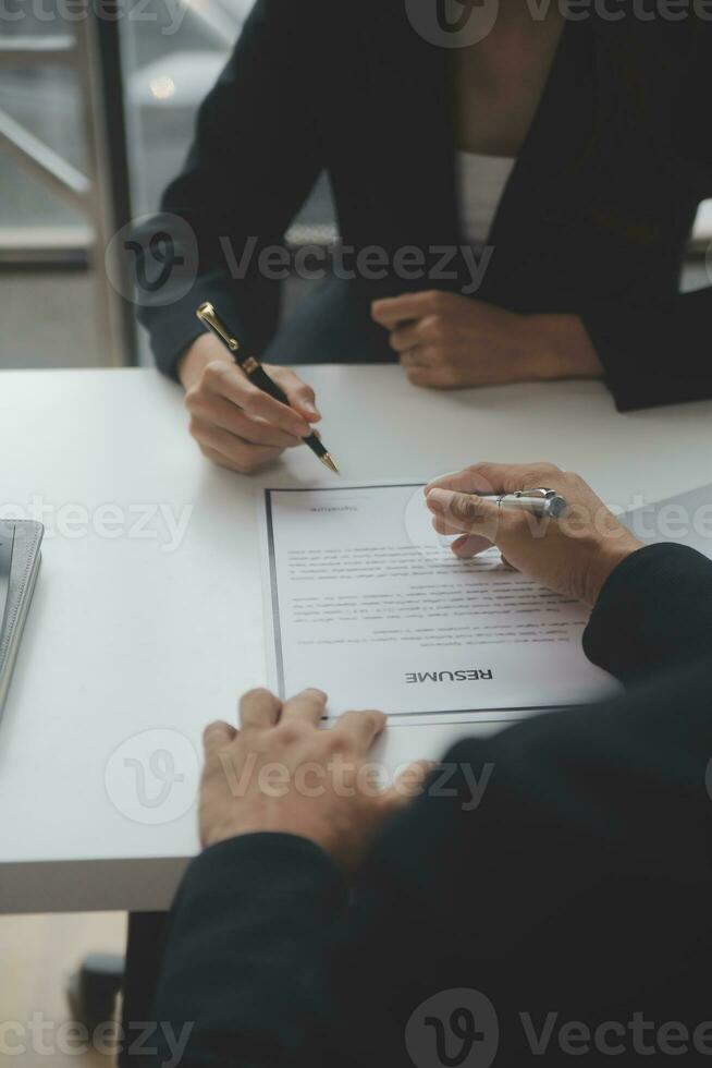 Close up view of job interview in office, focus on resume writing tips, employer reviewing good cv of prepared skilled applicant, recruiter considering application, hr manager making hiring decision photo