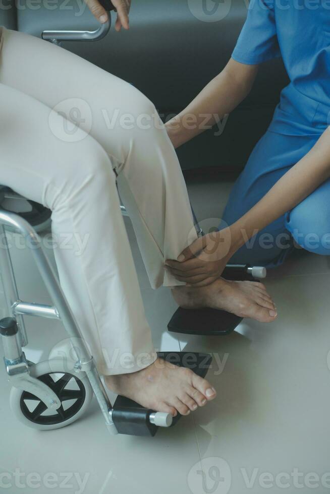 Asian young woman nurse at nursing home take care disabled senior man. Caregiver doctor serve physical therapy for older elderly patient to exercise and practice walking on walker or cane at backyard. photo