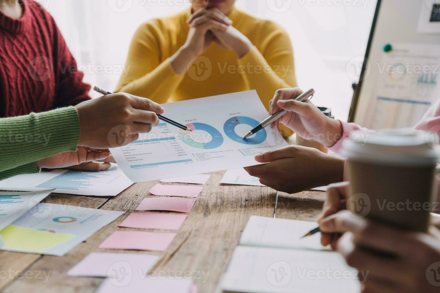 Financial analysts analyze business financial reports on a digital tablet planning investment project during a discussion at a meeting of corporate showing the results of their successful teamwork. photo