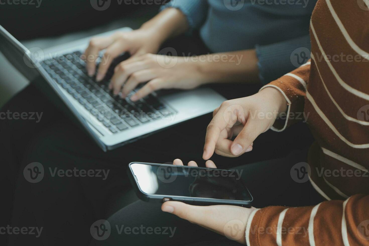 Asian Business woman using calculator and laptop for doing math finance on an office desk, tax, report, accounting, statistics, and analytical research concept photo