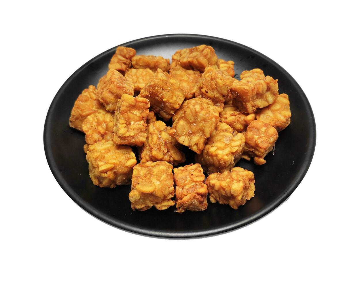 Fried tempeh, dice cutting, on black plate, on White Background. photo