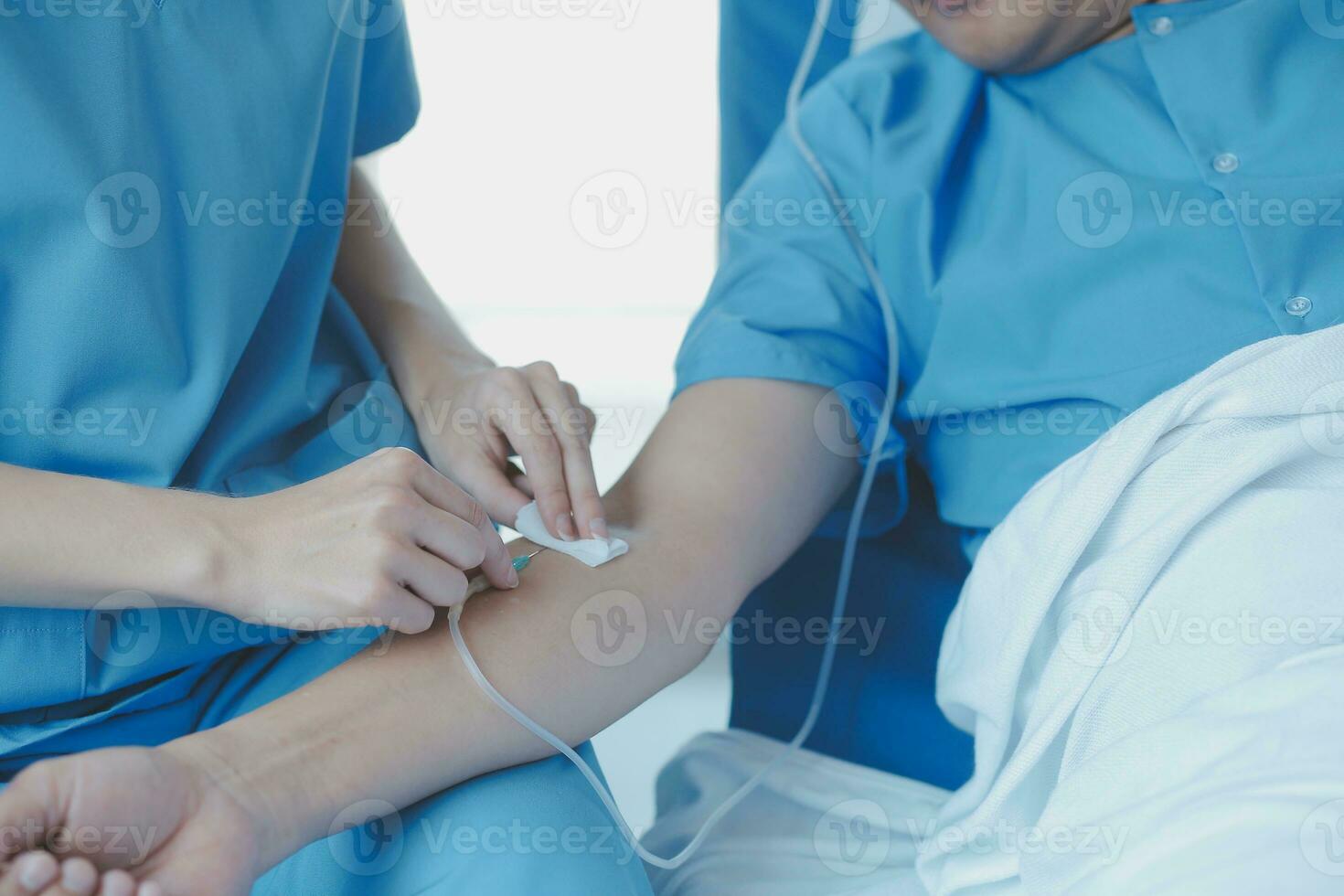 Injured patient showing doctor broken wrist and arm with bandage in hospital office or emergency room. Sprain, stress fracture or repetitive strain injury in hand. Nurse helping customer. First aid. photo