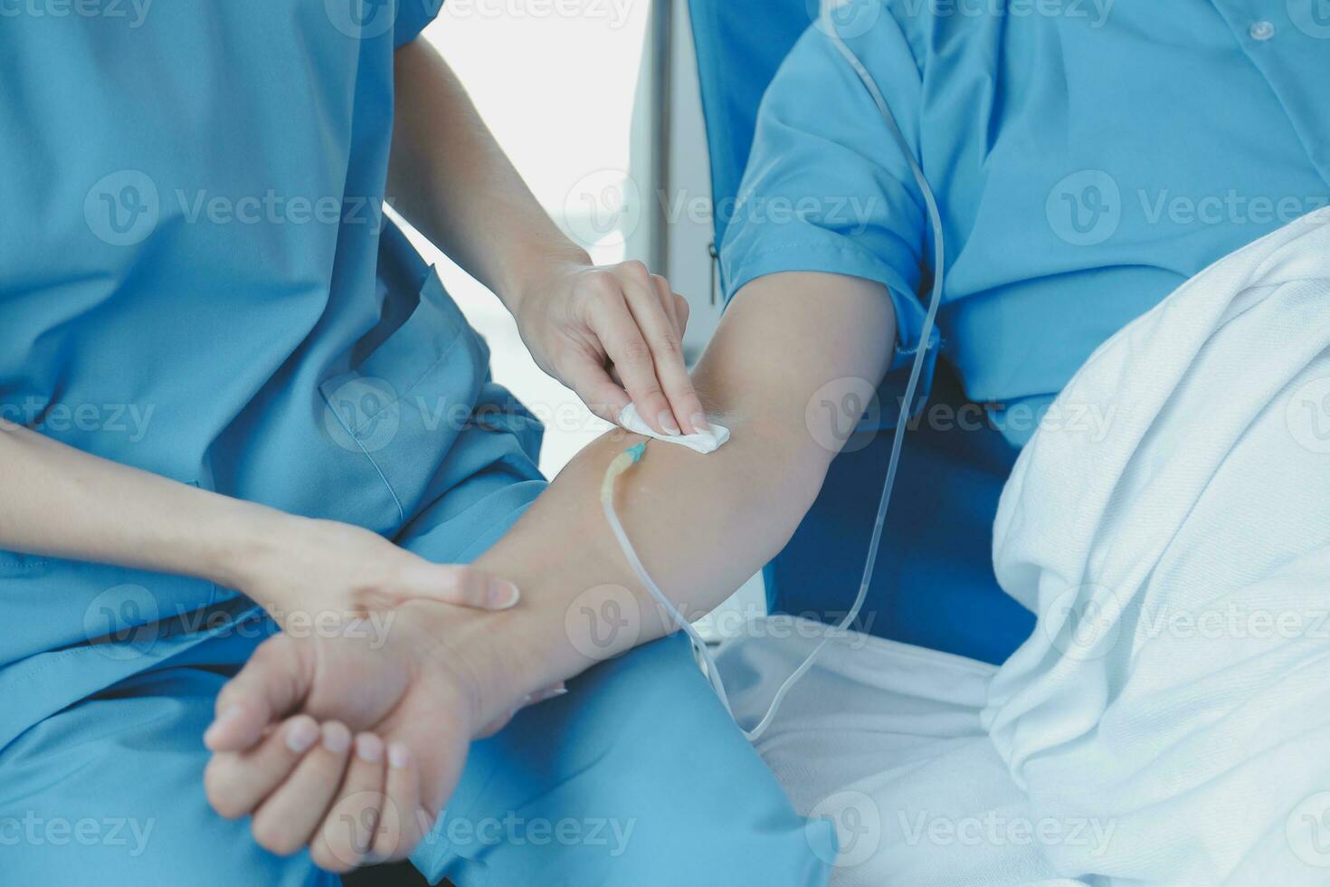 Injured patient showing doctor broken wrist and arm with bandage in hospital office or emergency room. Sprain, stress fracture or repetitive strain injury in hand. Nurse helping customer. First aid. photo