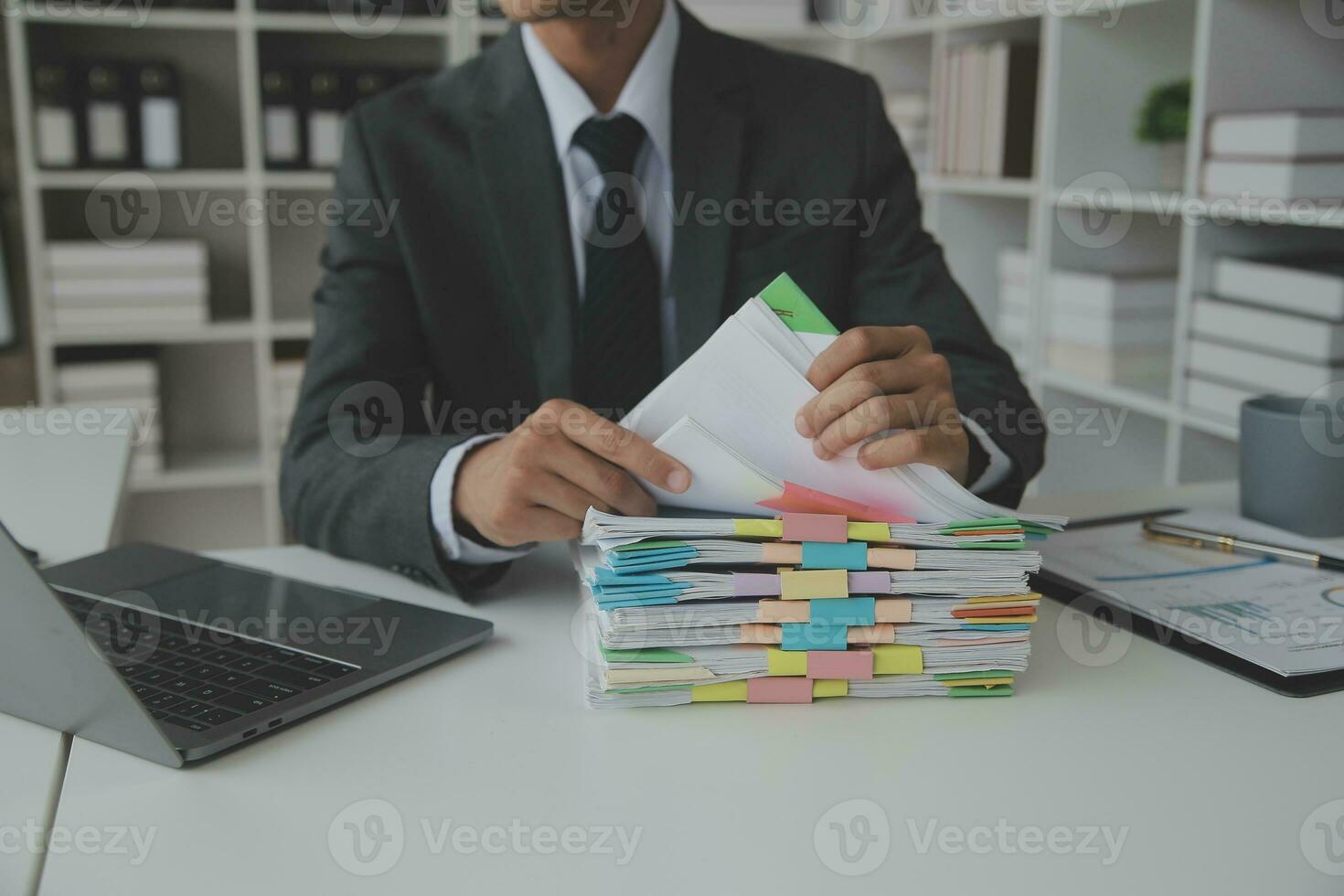 Group of confident business people point to graphs and charts to analyze market data, balance sheet, account, net profit to plan new sales strategies to increase production capacity. photo