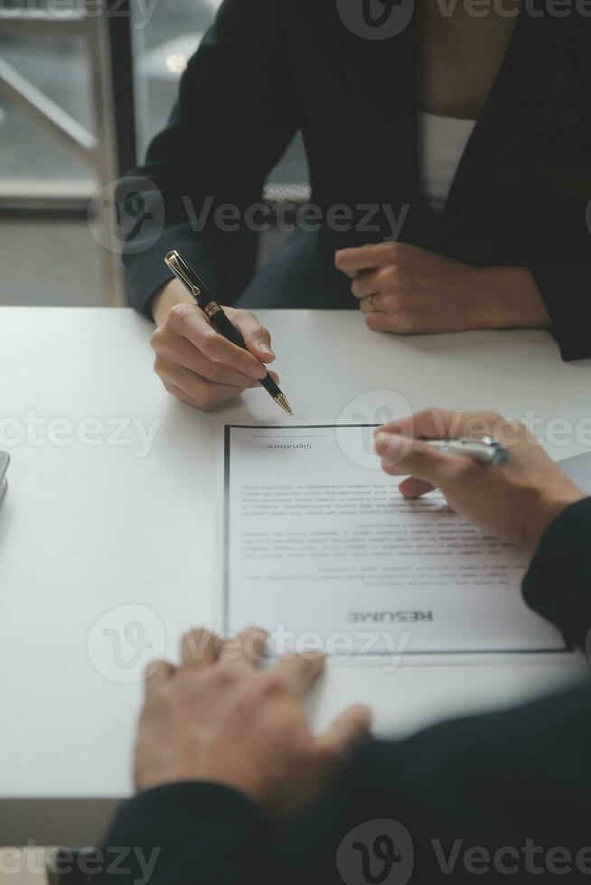 Close up view of job interview in office, focus on resume writing tips, employer reviewing good cv of prepared skilled applicant, recruiter considering application, hr manager making hiring decision photo