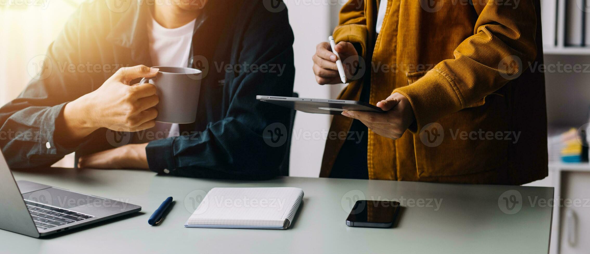 Close up ux developer and ui designer brainstorming about mobile app interface wireframe design on table with customer breif and color code at modern office.Creative digital development agency photo
