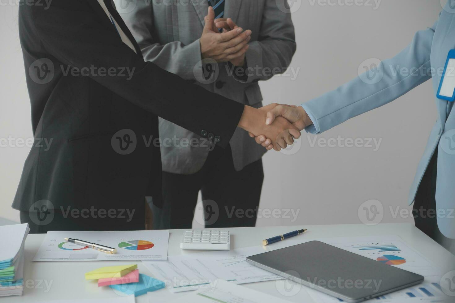 Financial analysts analyze business financial reports on a digital tablet planning investment project during a discussion at a meeting of corporate showing the results of their successful teamwork. photo