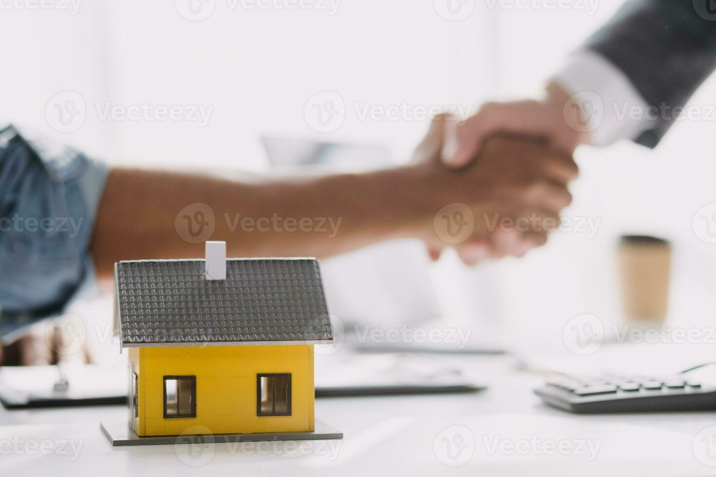 Real estate broker agent presenting and consult to customer to decision making sign insurance form agreement, buy and sell home model, concerning mortgage loan offer for and house insurance photo