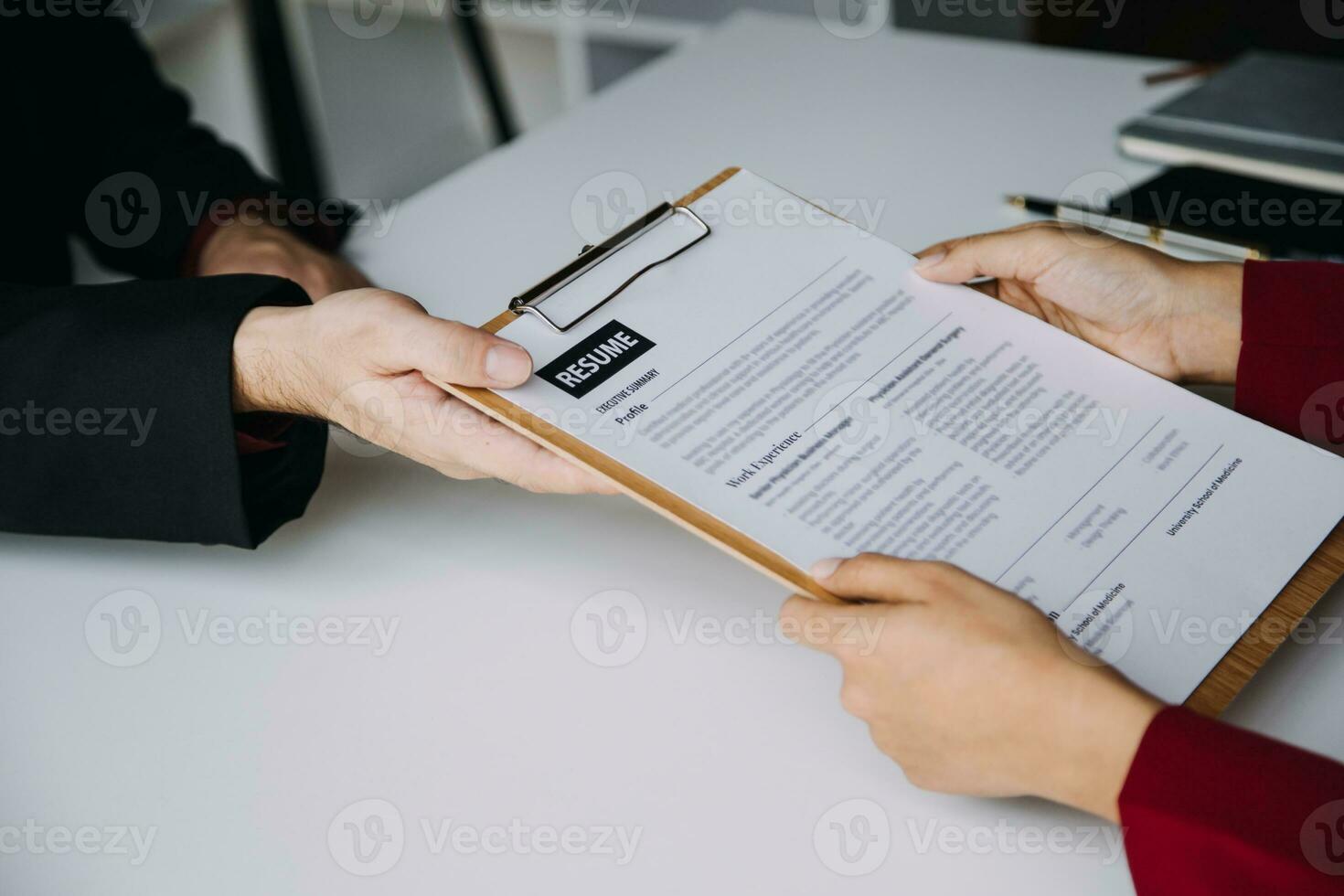 Close up view of job interview in office, focus on resume writing tips, employer reviewing good cv of prepared skilled applicant, recruiter considering application, hr manager making hiring decision photo