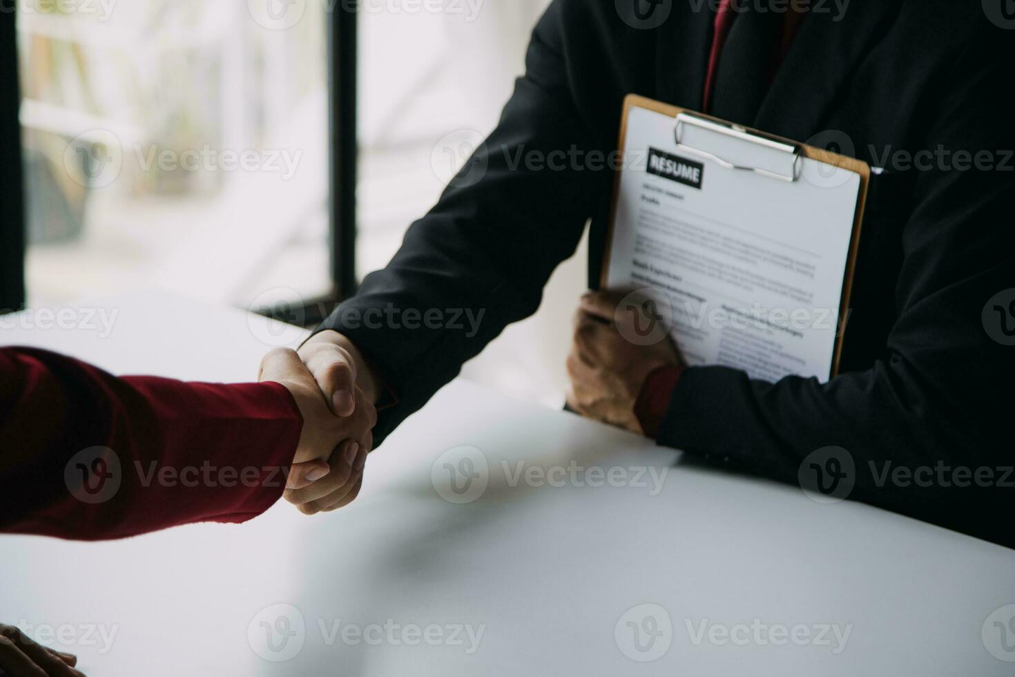 Close up view of job interview in office, focus on resume writing tips, employer reviewing good cv of prepared skilled applicant, recruiter considering application, hr manager making hiring decision photo