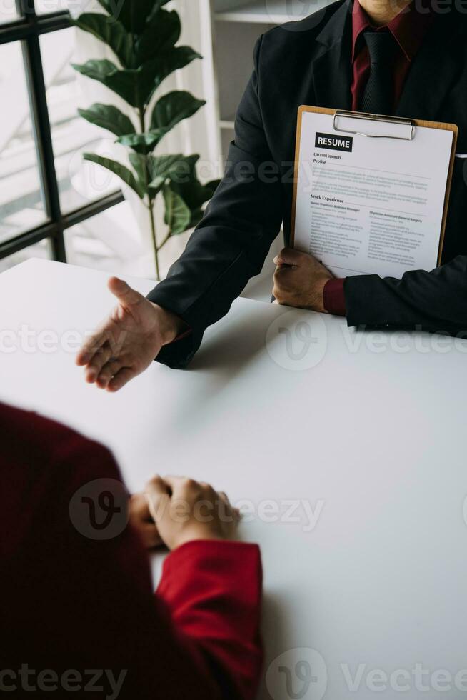 Close up view of job interview in office, focus on resume writing tips, employer reviewing good cv of prepared skilled applicant, recruiter considering application, hr manager making hiring decision photo
