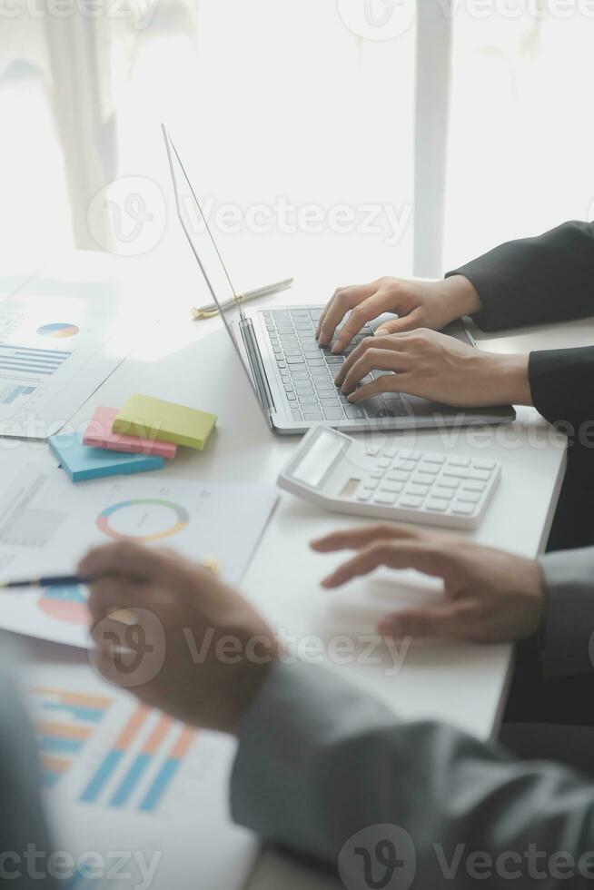 Financial analysts analyze business financial reports on a digital tablet planning investment project during a discussion at a meeting of corporate showing the results of their successful teamwork. photo
