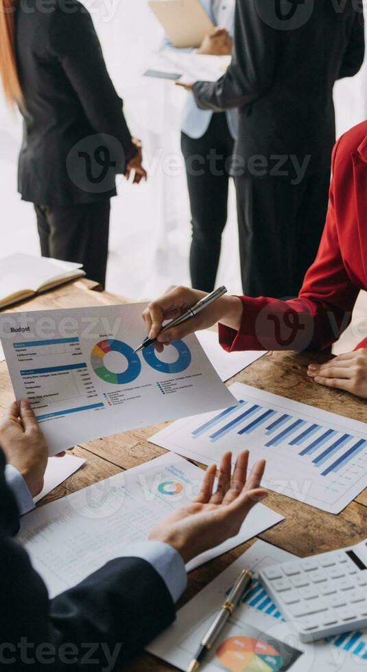 Financial analysts analyze business financial reports on a digital tablet planning investment project during a discussion at a meeting of corporate showing the results of their successful teamwork. photo