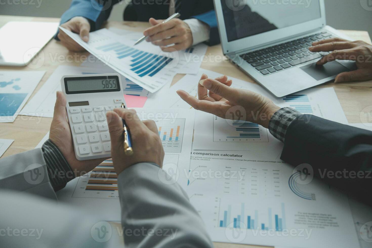 Group of confident business people point to graphs and charts to analyze market data, balance sheet, account, net profit to plan new sales strategies to increase production capacity. photo