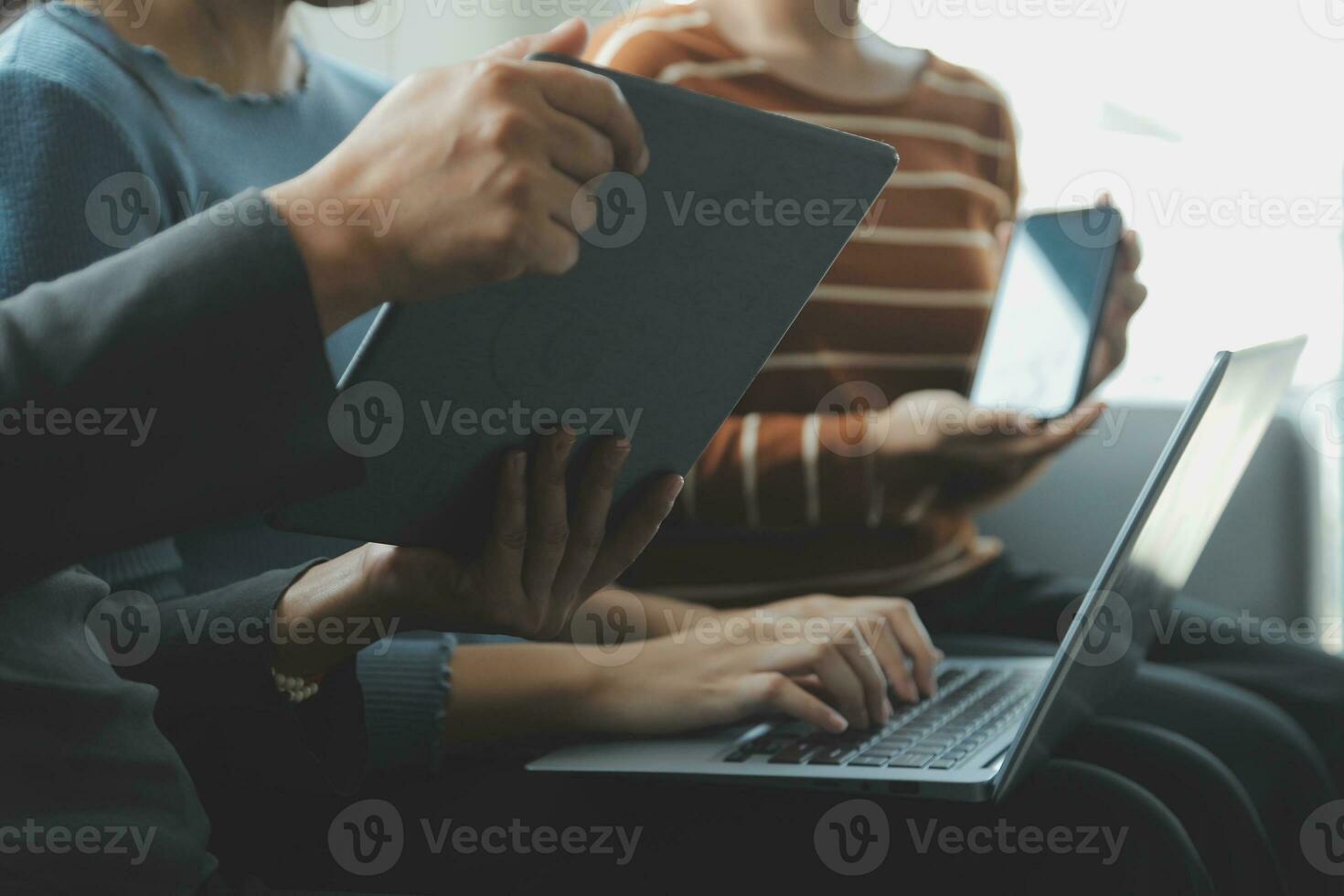 Asian Business woman using calculator and laptop for doing math finance on an office desk, tax, report, accounting, statistics, and analytical research concept photo