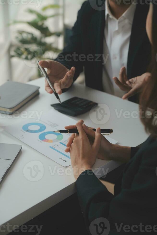 Financial analysts analyze business financial reports on a digital tablet planning investment project during a discussion at a meeting of corporate showing the results of their successful teamwork. photo