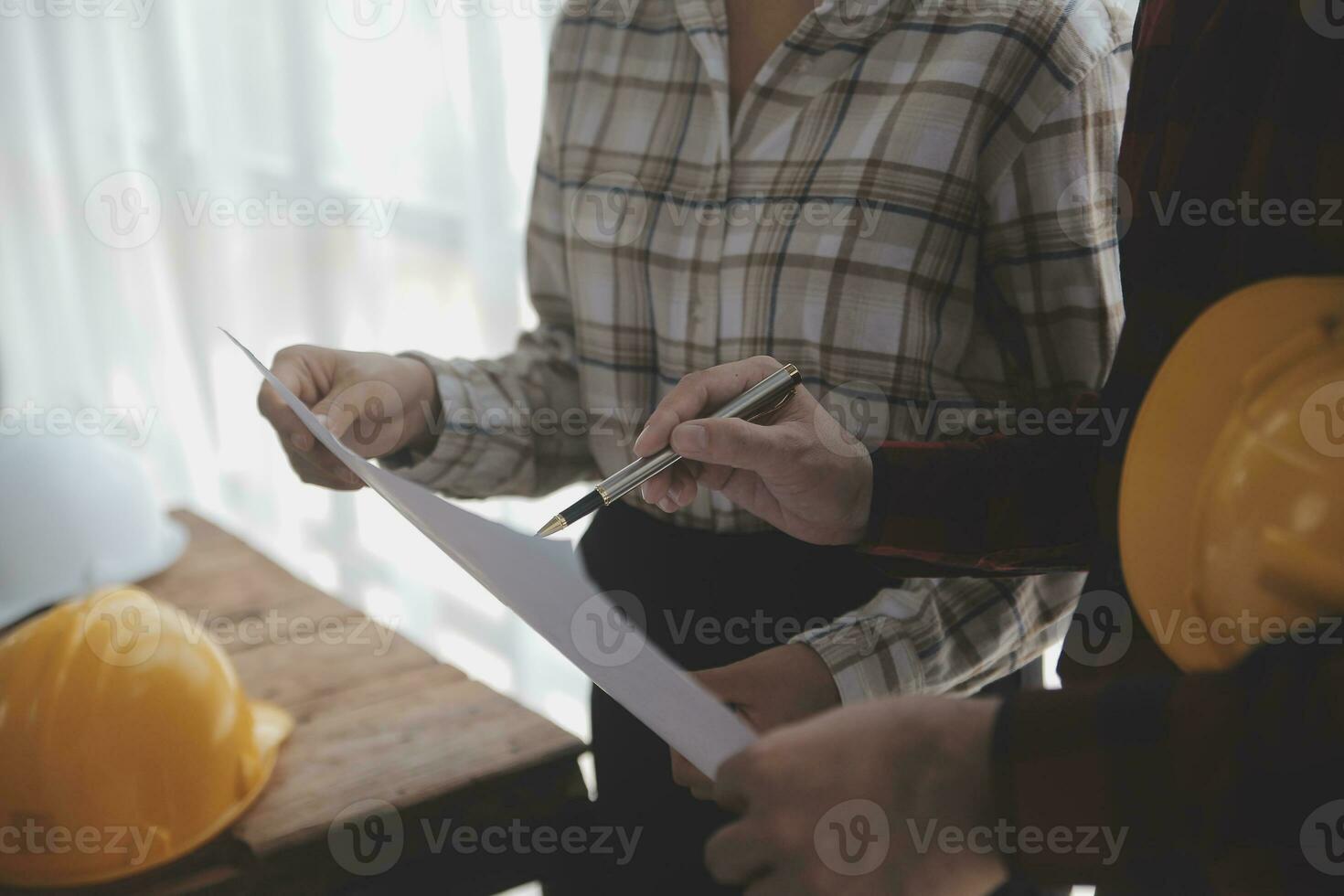 Two business man construction site engineer. Engineering objects on workplace with partners interacting on background photo