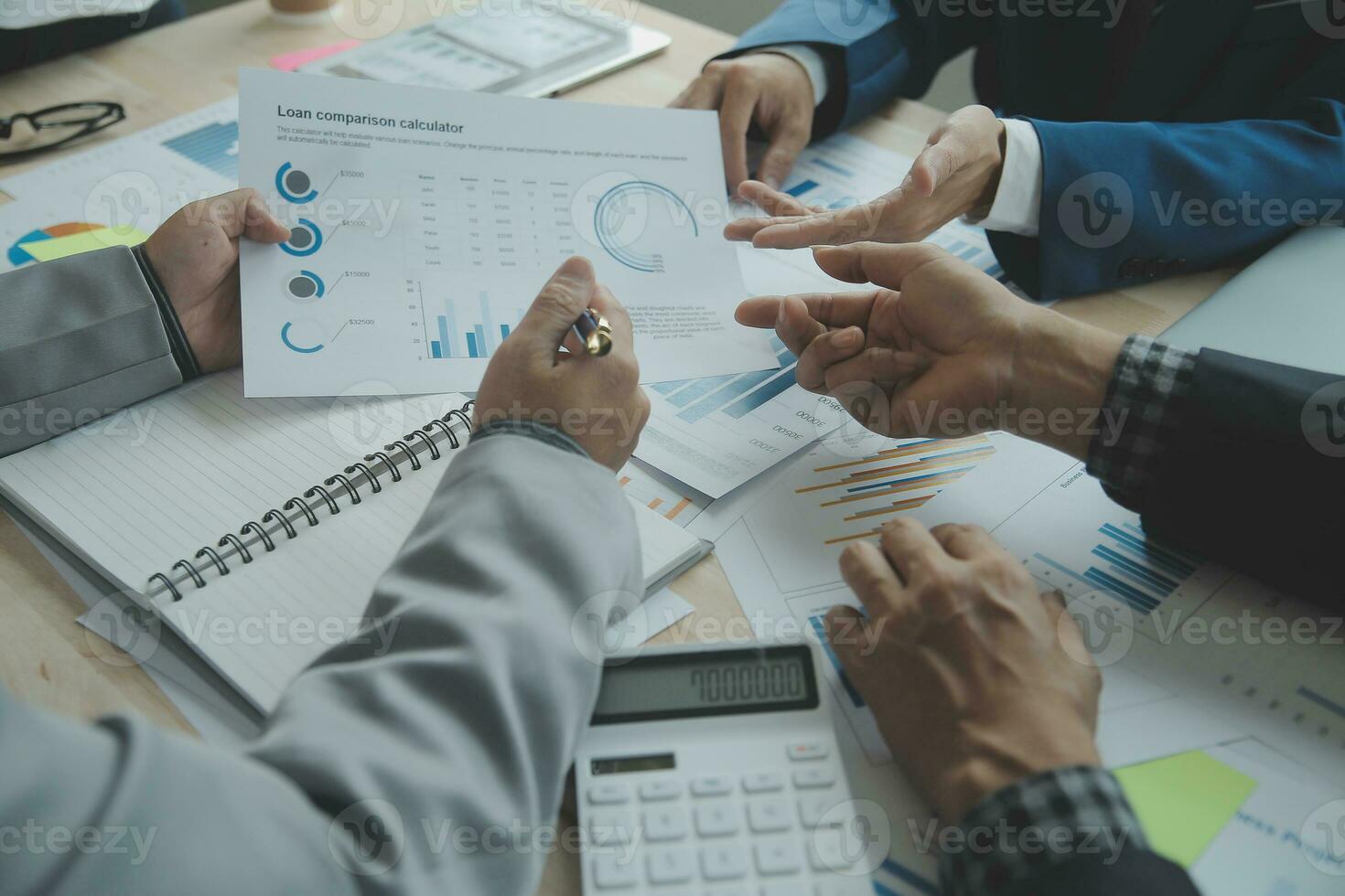 Group of confident business people point to graphs and charts to analyze market data, balance sheet, account, net profit to plan new sales strategies to increase production capacity. photo