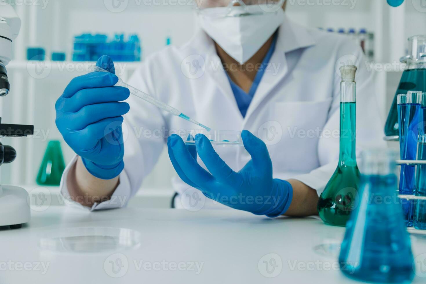 microscope with lab glassware, science laboratory research and development concept photo