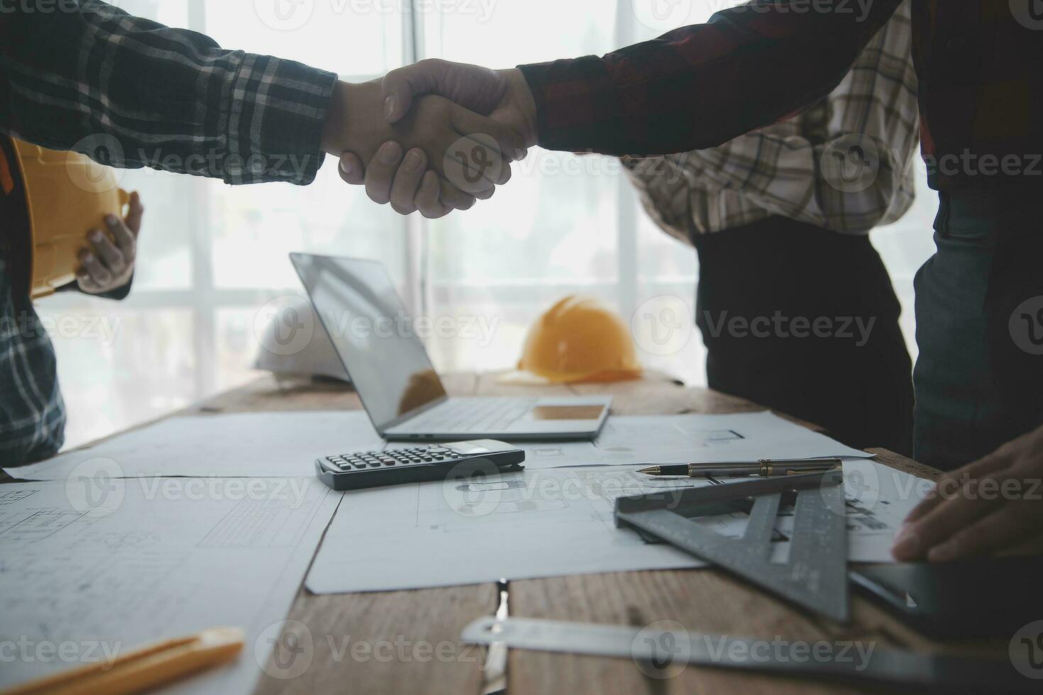 Two business man construction site engineer. Engineering objects on workplace with partners interacting on background photo