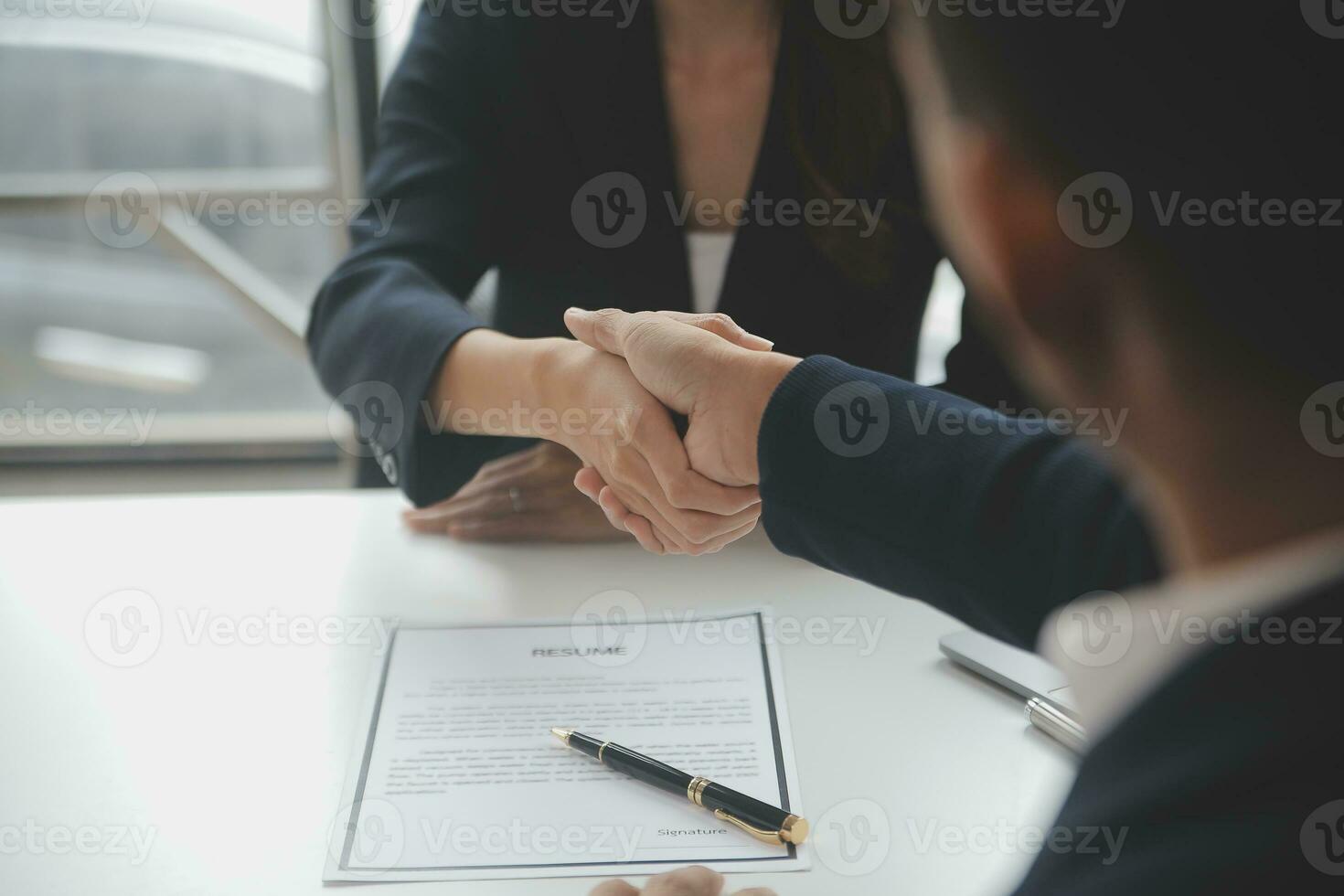 Close up view of job interview in office, focus on resume writing tips, employer reviewing good cv of prepared skilled applicant, recruiter considering application, hr manager making hiring decision photo