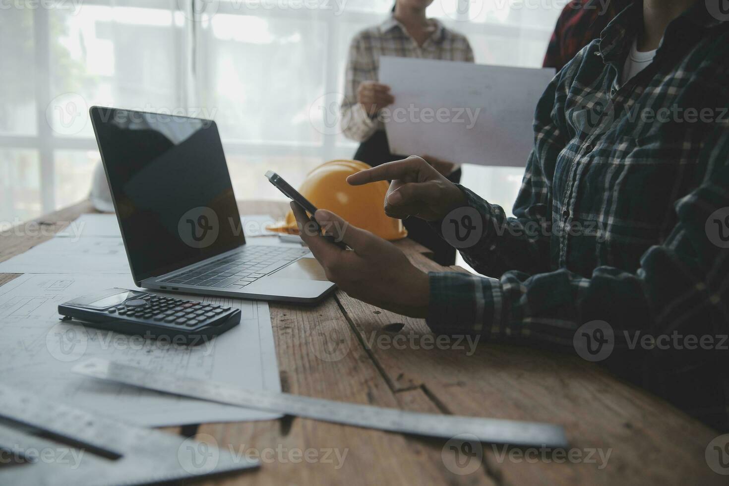 Two business man construction site engineer. Engineering objects on workplace with partners interacting on background photo