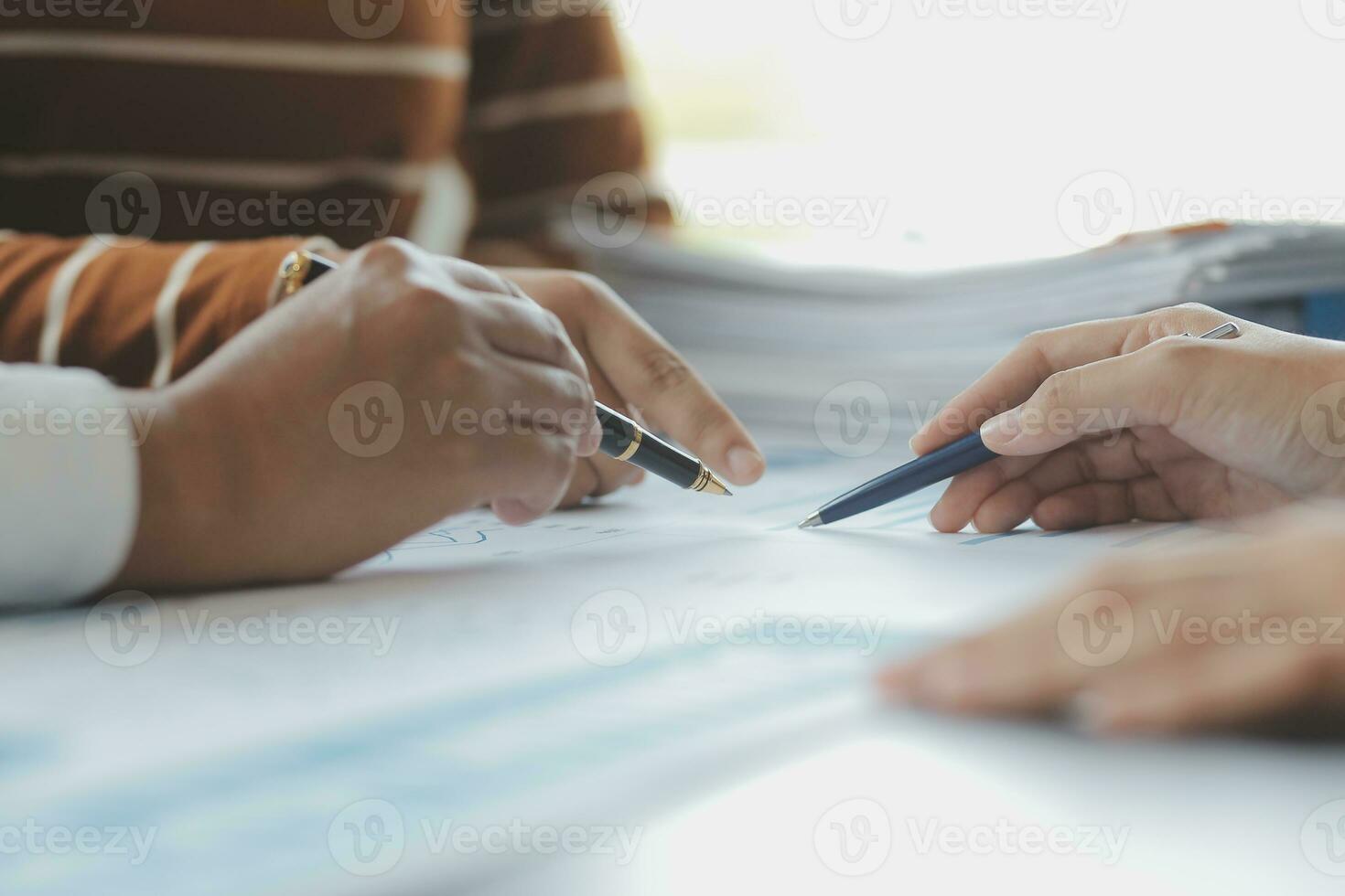 Financial analysts analyze business financial reports on a digital tablet planning investment project during a discussion at a meeting of corporate showing the results of their successful teamwork. photo