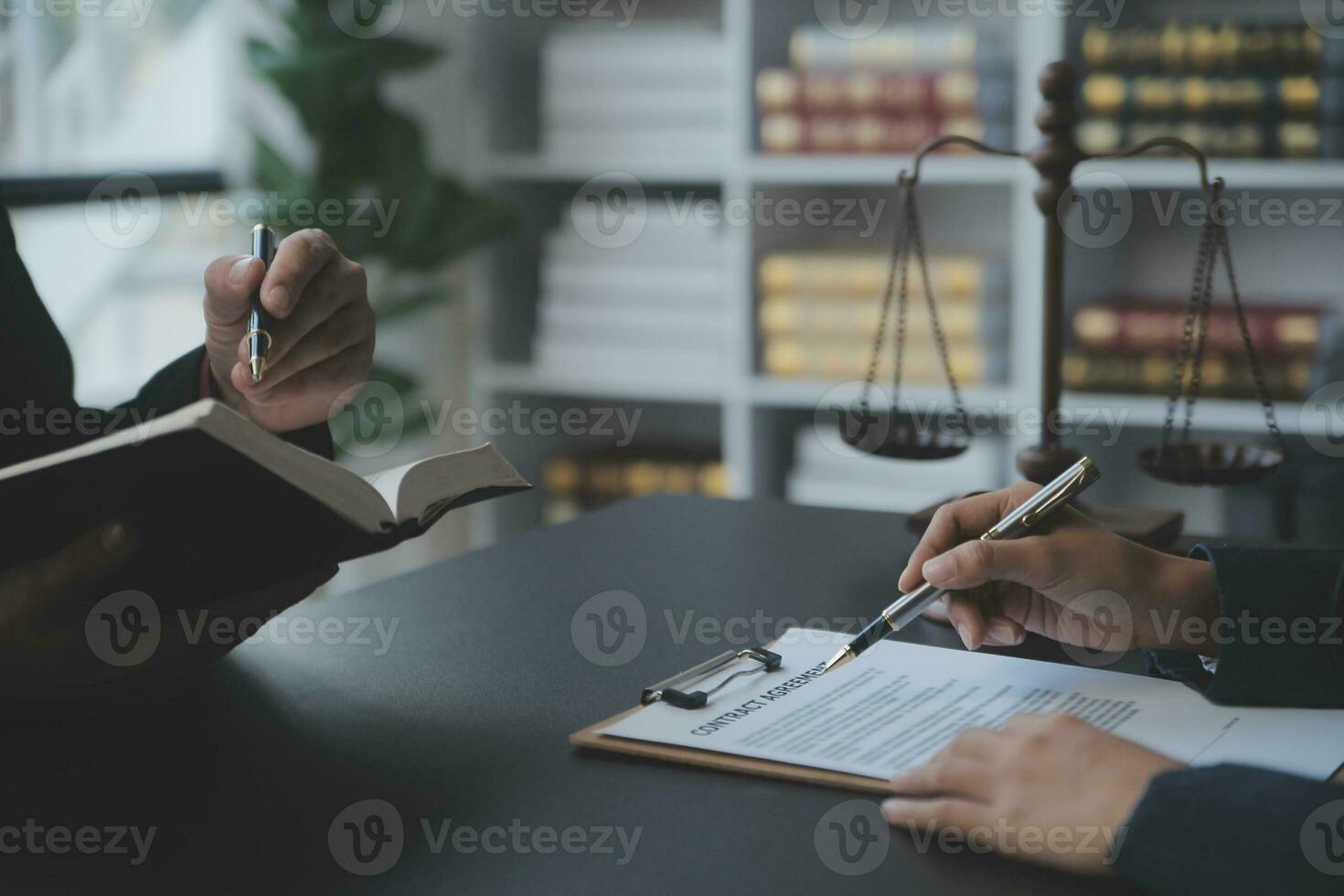 Business and lawyers discussing contract papers with brass scale on desk in office. Law, legal services, advice, justice and law concept picture with film grain effect photo